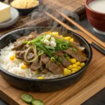 Sizzling Pepper Lunch with beef, rice, and corn on a hotplate, garnished with butter and green onions.